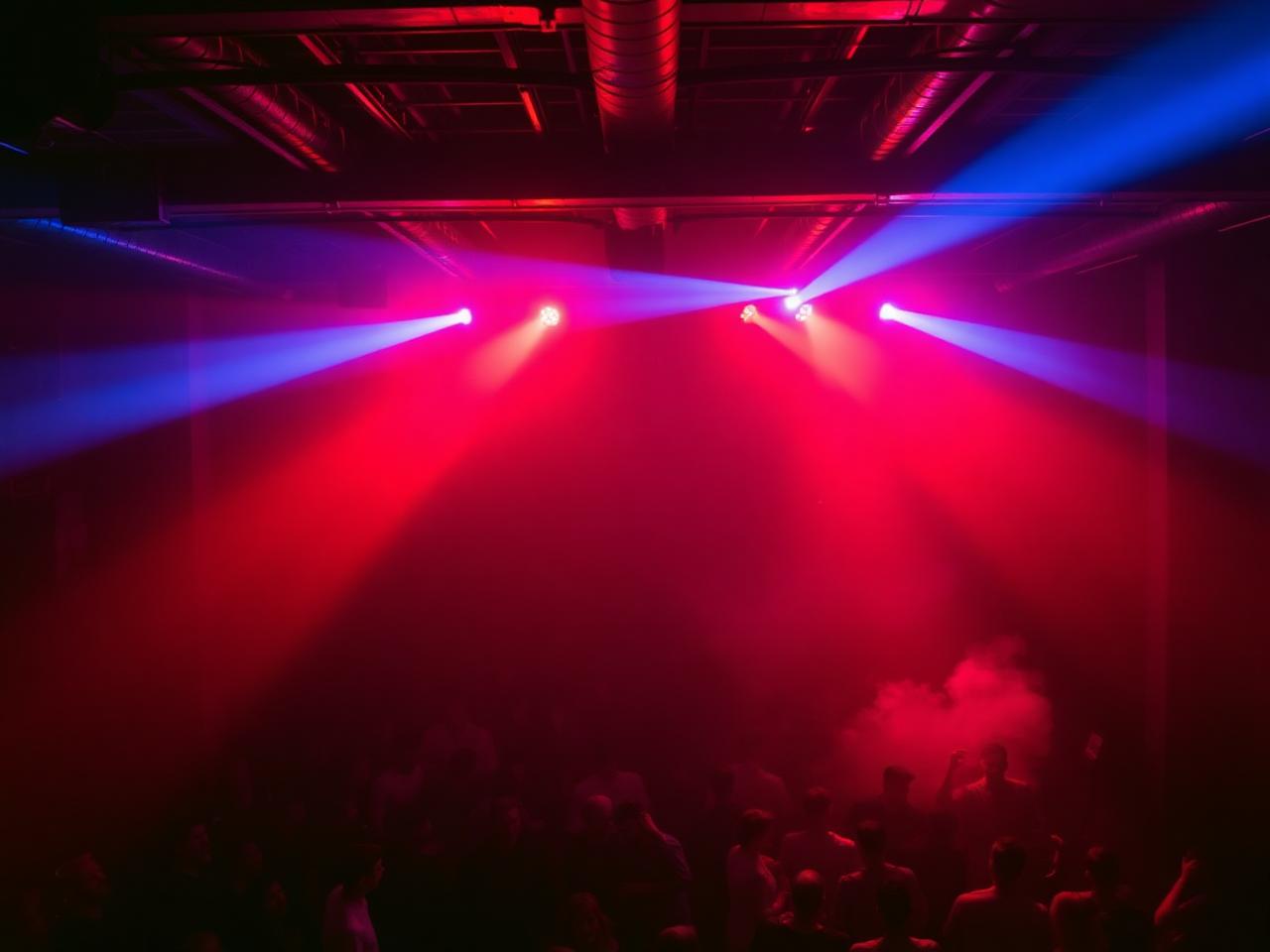 Industrial Los Angeles club with red and blue lighting and a packed dance floor